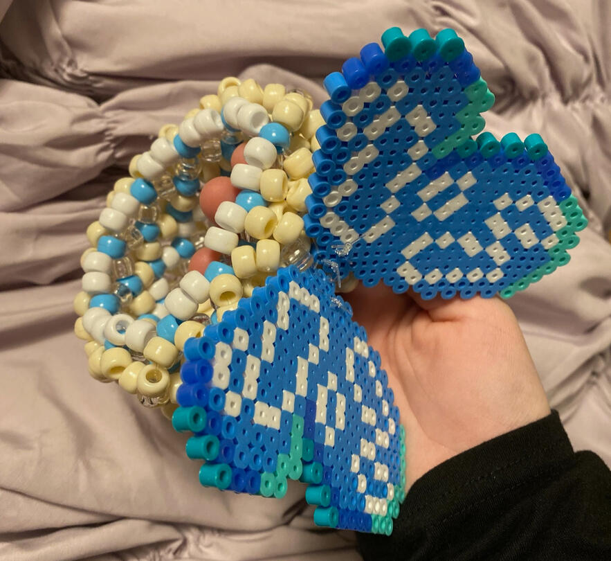 Kandi cuff with a pearler bead attachment.